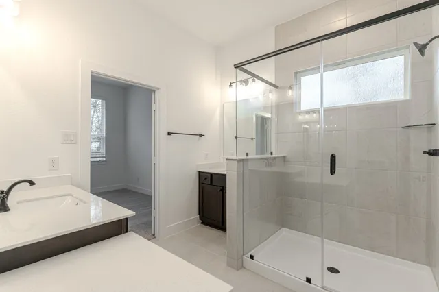 a bathroom with a bathtub and a shower