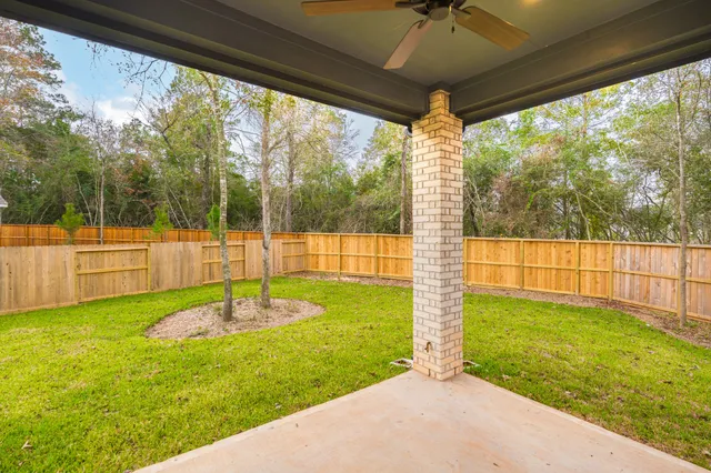 a view of house with a yard and potted plants