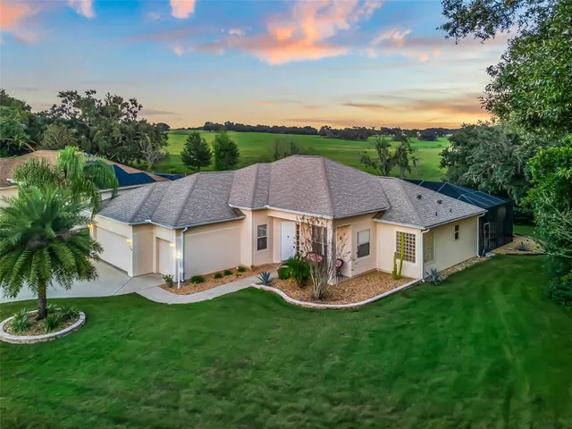 an aerial view of a house with yard swimming pool and outdoor seating