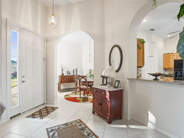 a kitchen with kitchen island granite countertop a stove microwave and sink