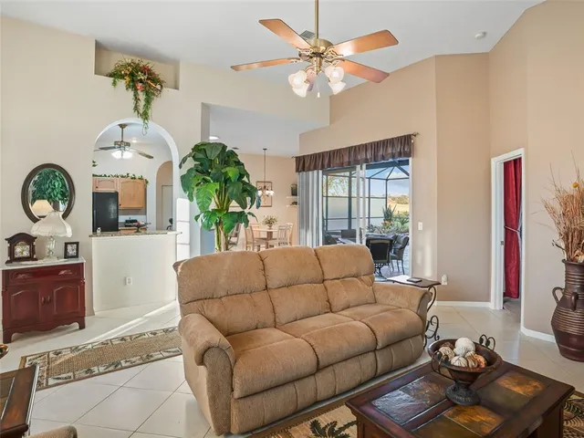 a spacious bedroom with a bed and a flat screen tv