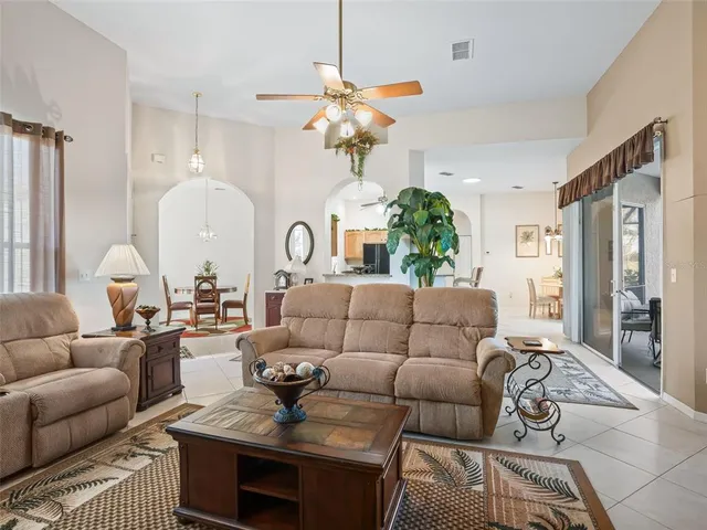 a bedroom with two beds and a chandelier