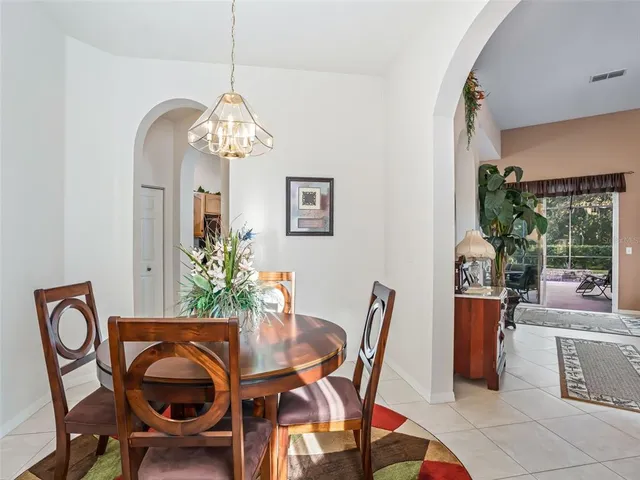 a bedroom with two beds and a chandelier