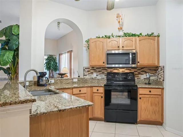 an aerial view of a house with a garden and swimming pool