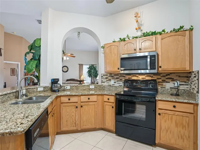 an aerial view of a house with a yard basket ball court and outdoor seating