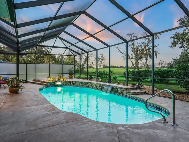 a living room with furniture a window and a flat screen tv