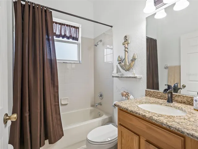 an aerial view of residential houses with outdoor space and swimming pool