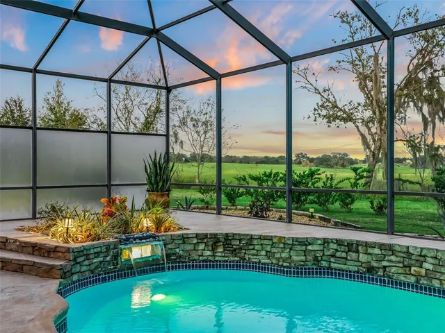 a living room with furniture a chandelier and a window