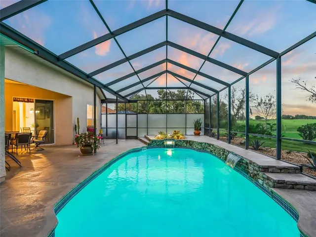a bedroom with a bed table flowerpot and window