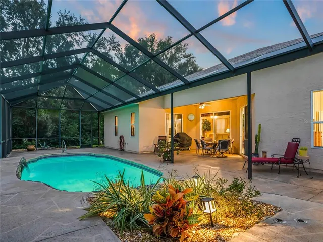 a living room with furniture a clock on wall and a window