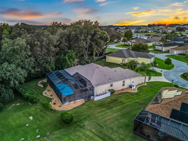a living room with furniture a chandelier and a rug