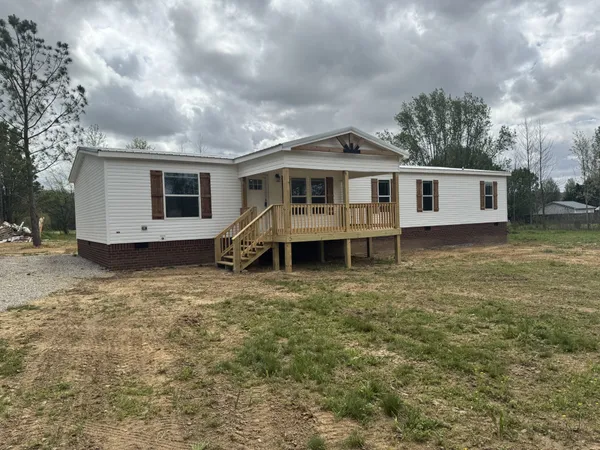 a view of a house with a backyard