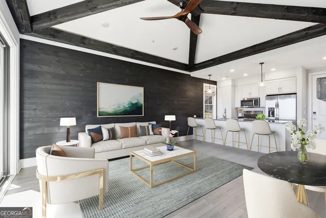 a living room with furniture and a chandelier