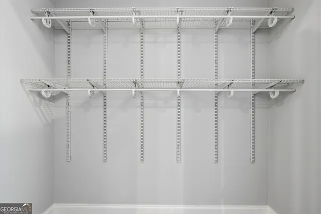 a bathroom with a granite countertop sink a mirror and shower