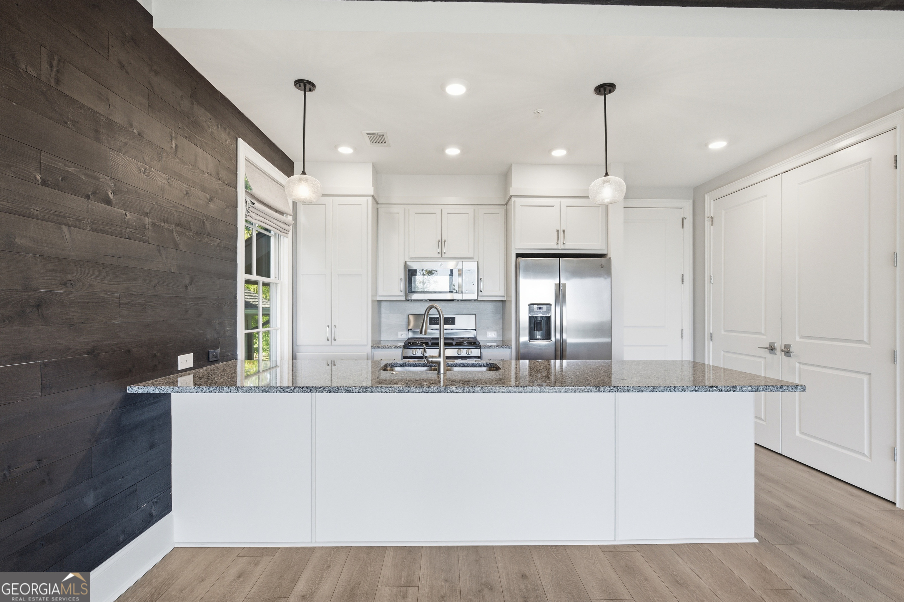 17 Cottage Lane, Unit 202 Toccoa, GA 30577 - Photo 10 of 43 a large kitchen with kitchen island a large counter space a sink appliances and cabinets