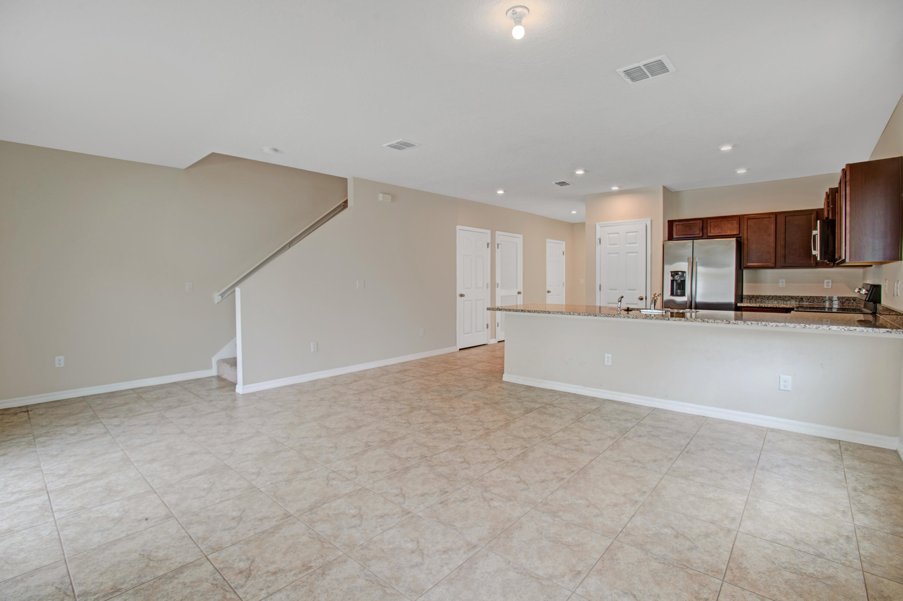 3343 Liberty Square Way, Unit 104 Fort Pierce, FL 34982 - Photo 12 of 34 a view of a kitchen with a sink and cabinets