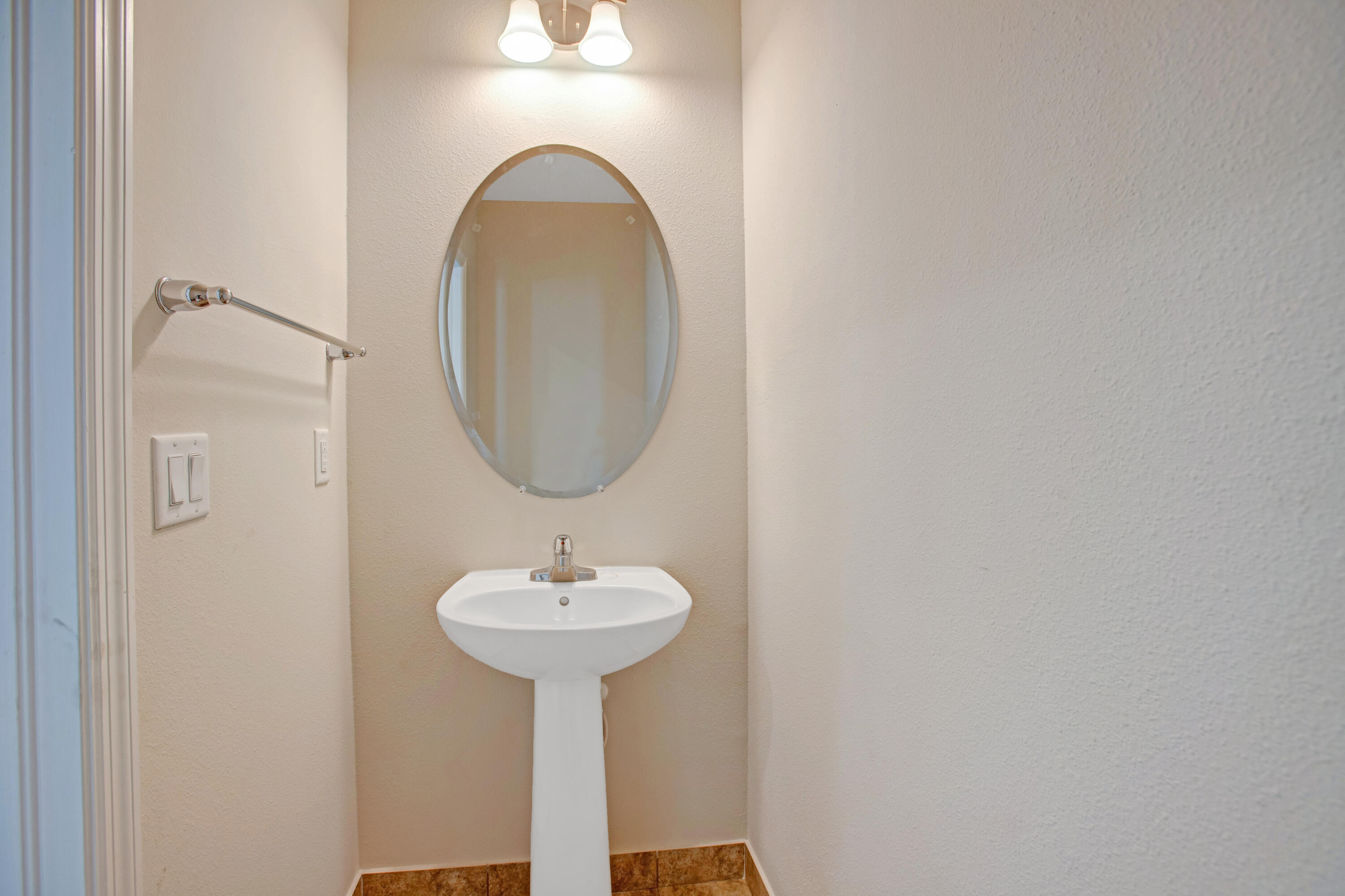 3343 Liberty Square Way, Unit 104 Fort Pierce, FL 34982 - Photo 13 of 34 a bathroom with a sink and a mirror