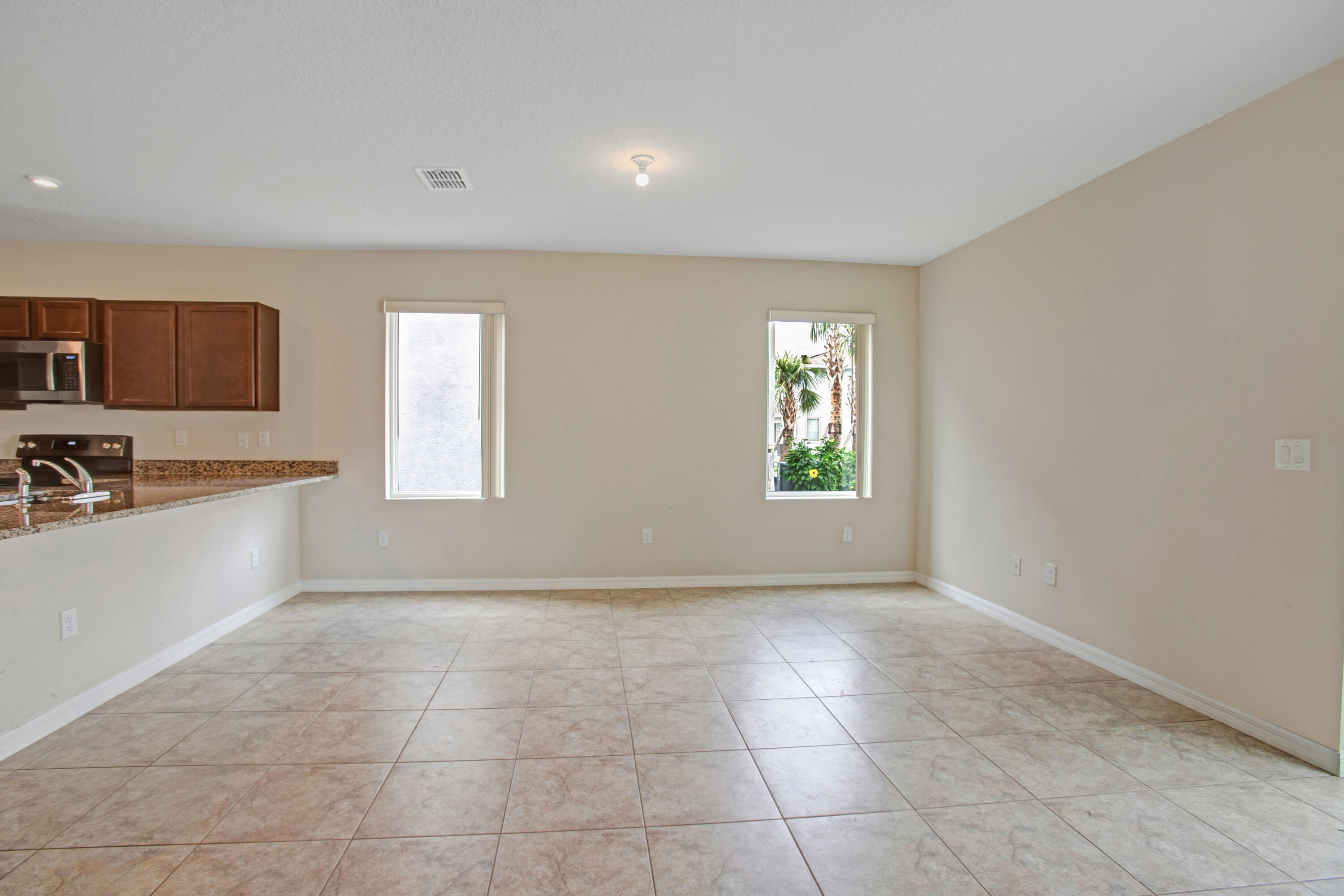 3343 Liberty Square Way, Unit 104 Fort Pierce, FL 34982 - Photo 14 of 34 a view of an empty room with window and cabinet