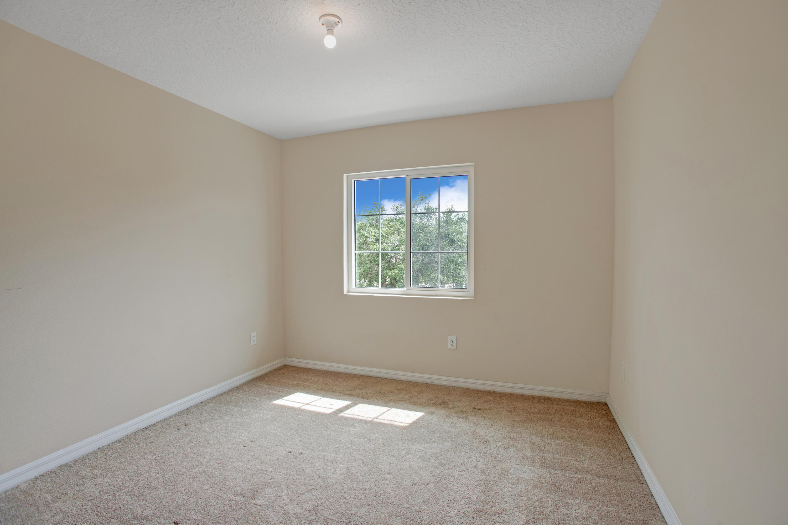 3343 Liberty Square Way, Unit 104 Fort Pierce, FL 34982 - Photo 15 of 34 an empty room with a window
