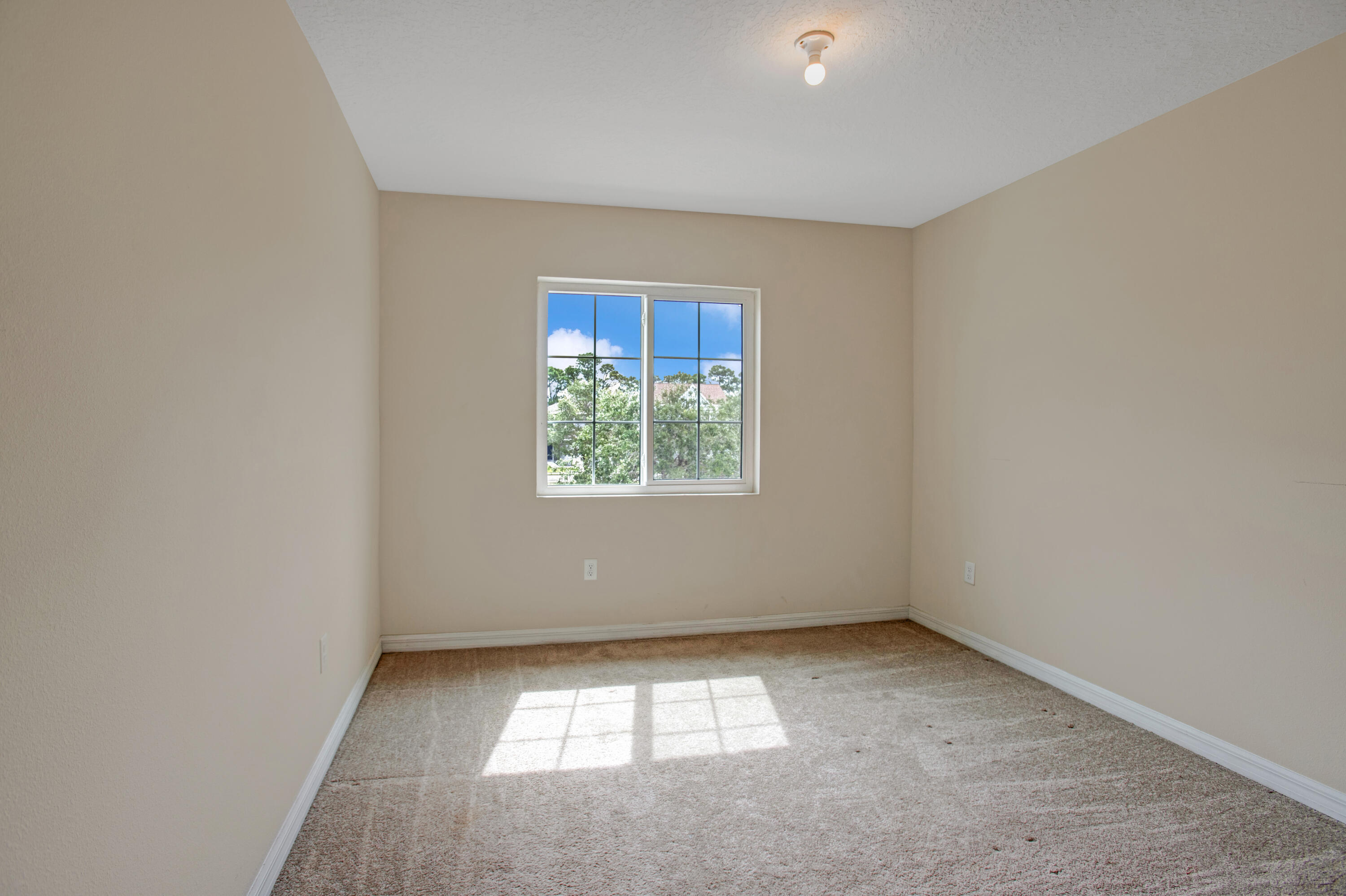 3343 Liberty Square Way, Unit 104 Fort Pierce, FL 34982 - Photo 17 of 34 an empty room with a window