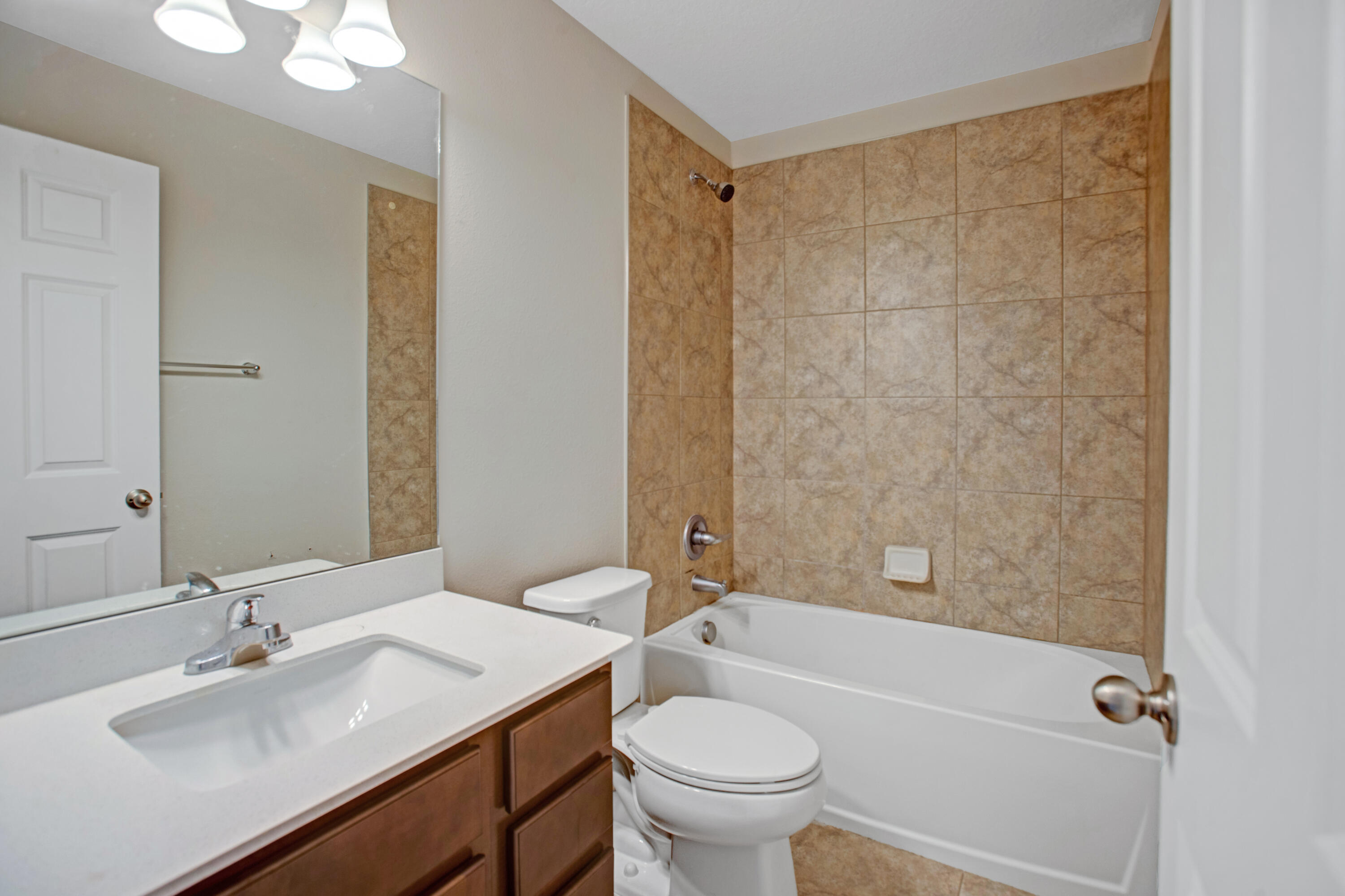 3343 Liberty Square Way, Unit 104 Fort Pierce, FL 34982 - Photo 19 of 34 a bathroom with a sink toilet tub and shower