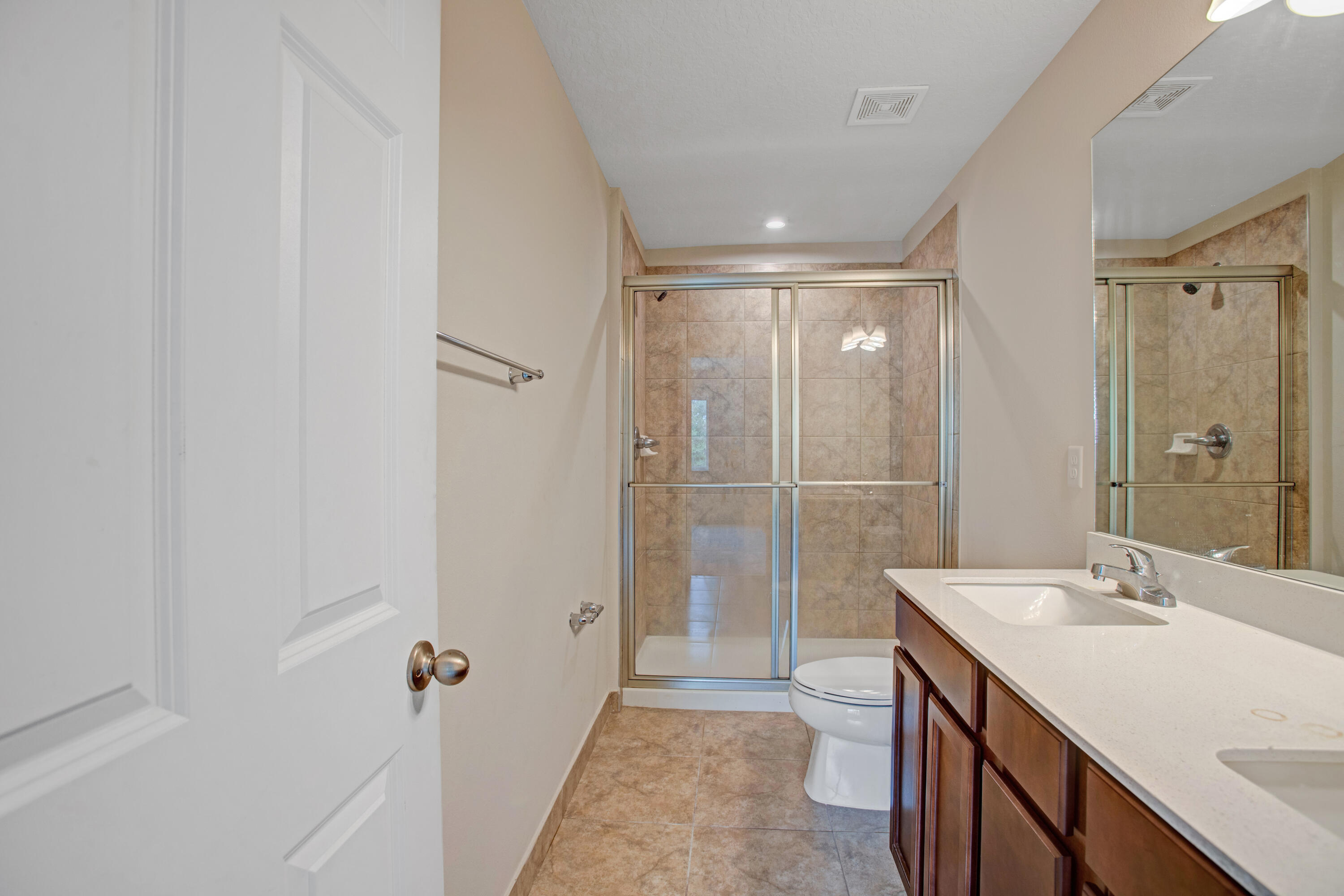 3343 Liberty Square Way, Unit 104 Fort Pierce, FL 34982 - Photo 25 of 34 a bathroom with a sink a toilet and shower