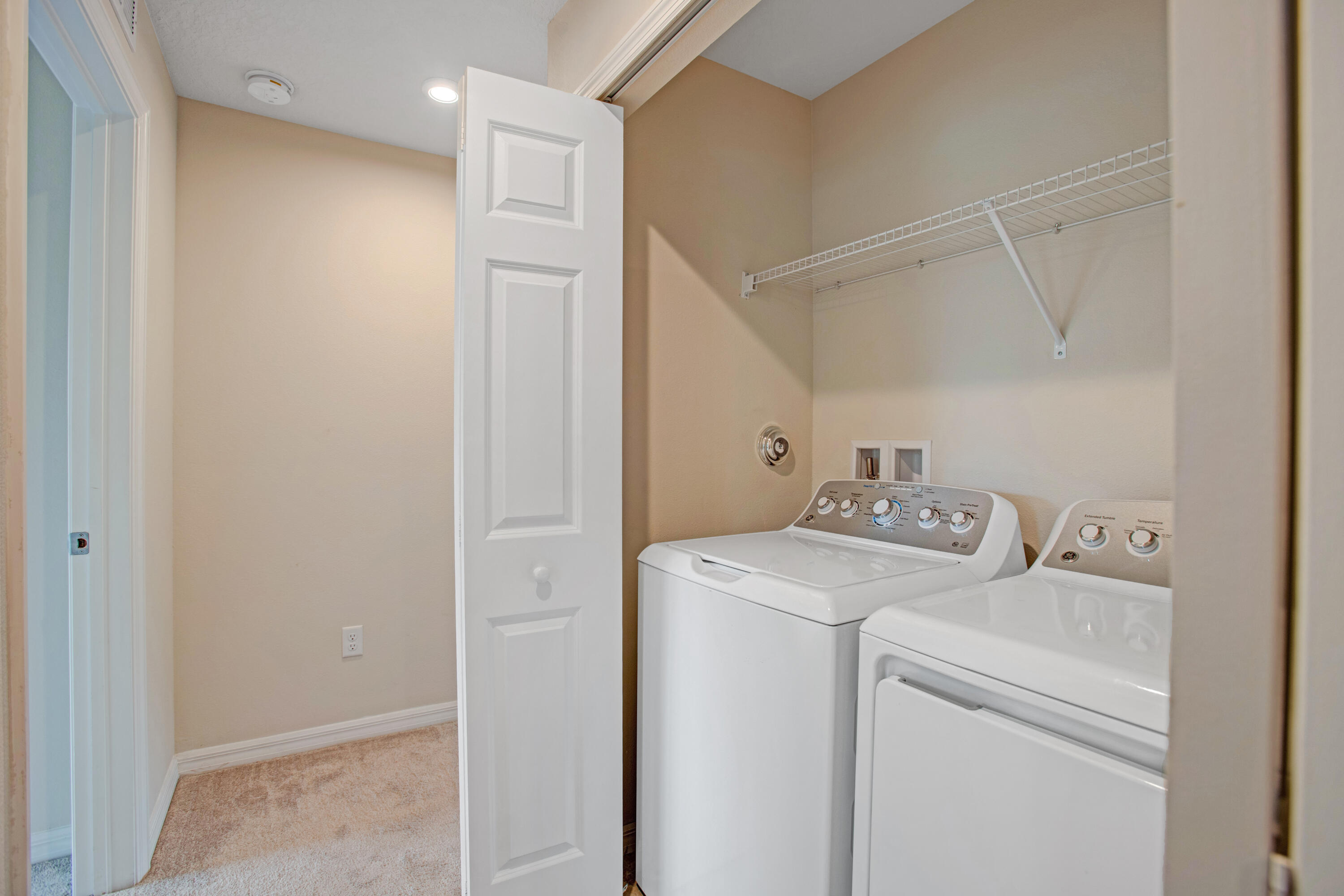 3343 Liberty Square Way, Unit 104 Fort Pierce, FL 34982 - Photo 27 of 34 a view of storage and utility room with washer and dryer