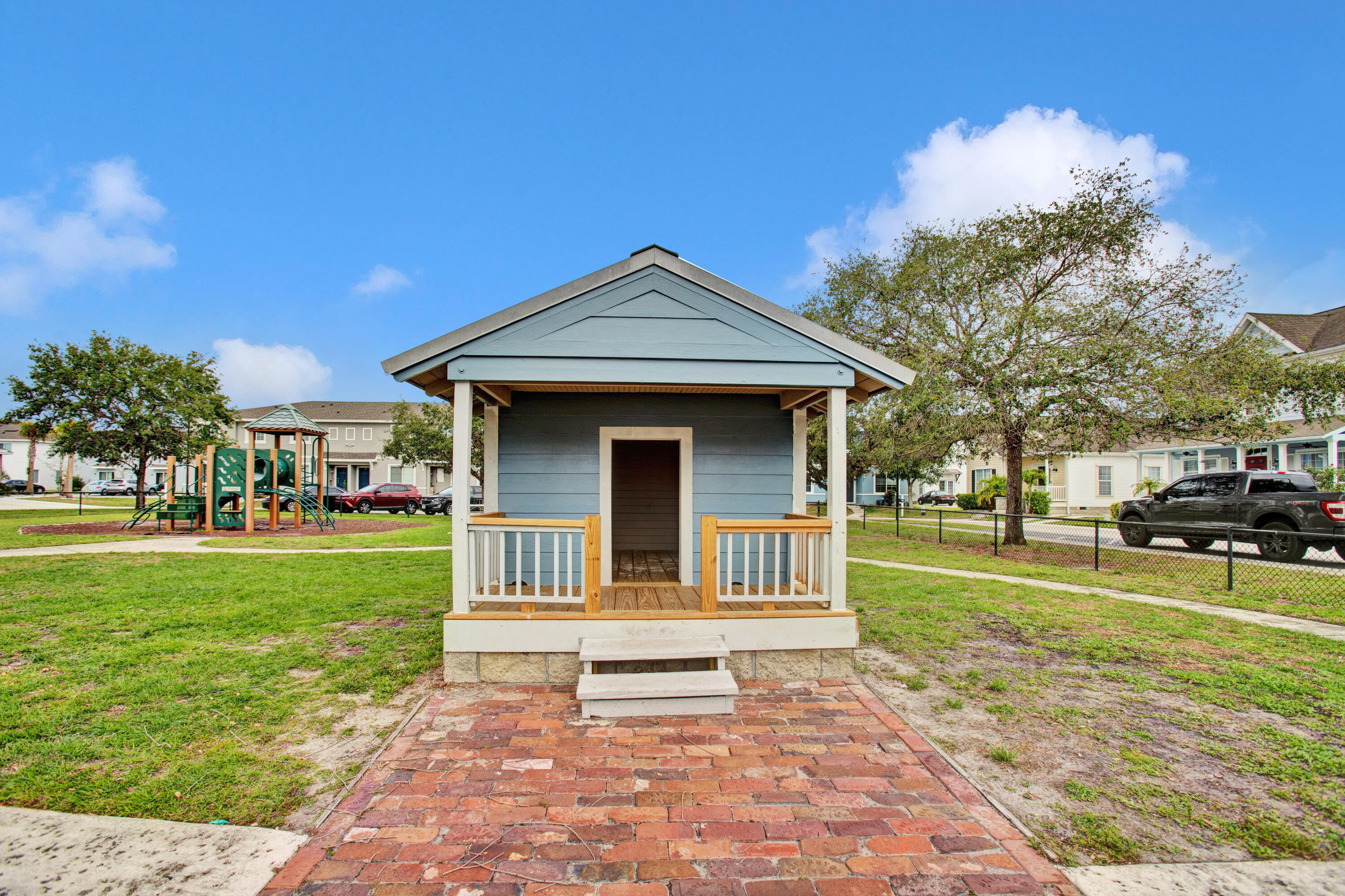 3343 Liberty Square Way, Unit 104 Fort Pierce, FL 34982 - Photo 29 of 34 a front view of a house with a yard
