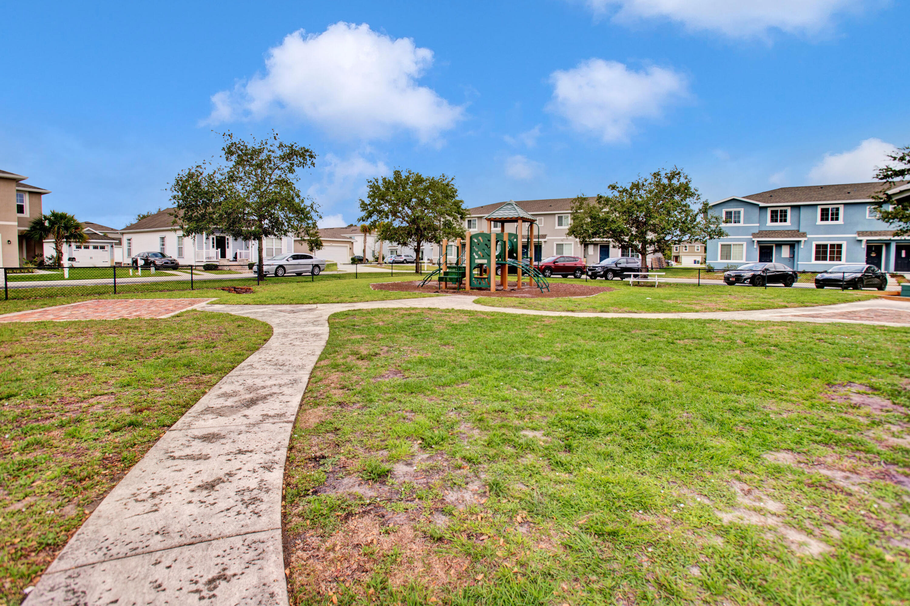3343 Liberty Square Way, Unit 104 Fort Pierce, FL 34982 - Photo 30 of 34 a view of a fountain in front of a house with a big yard