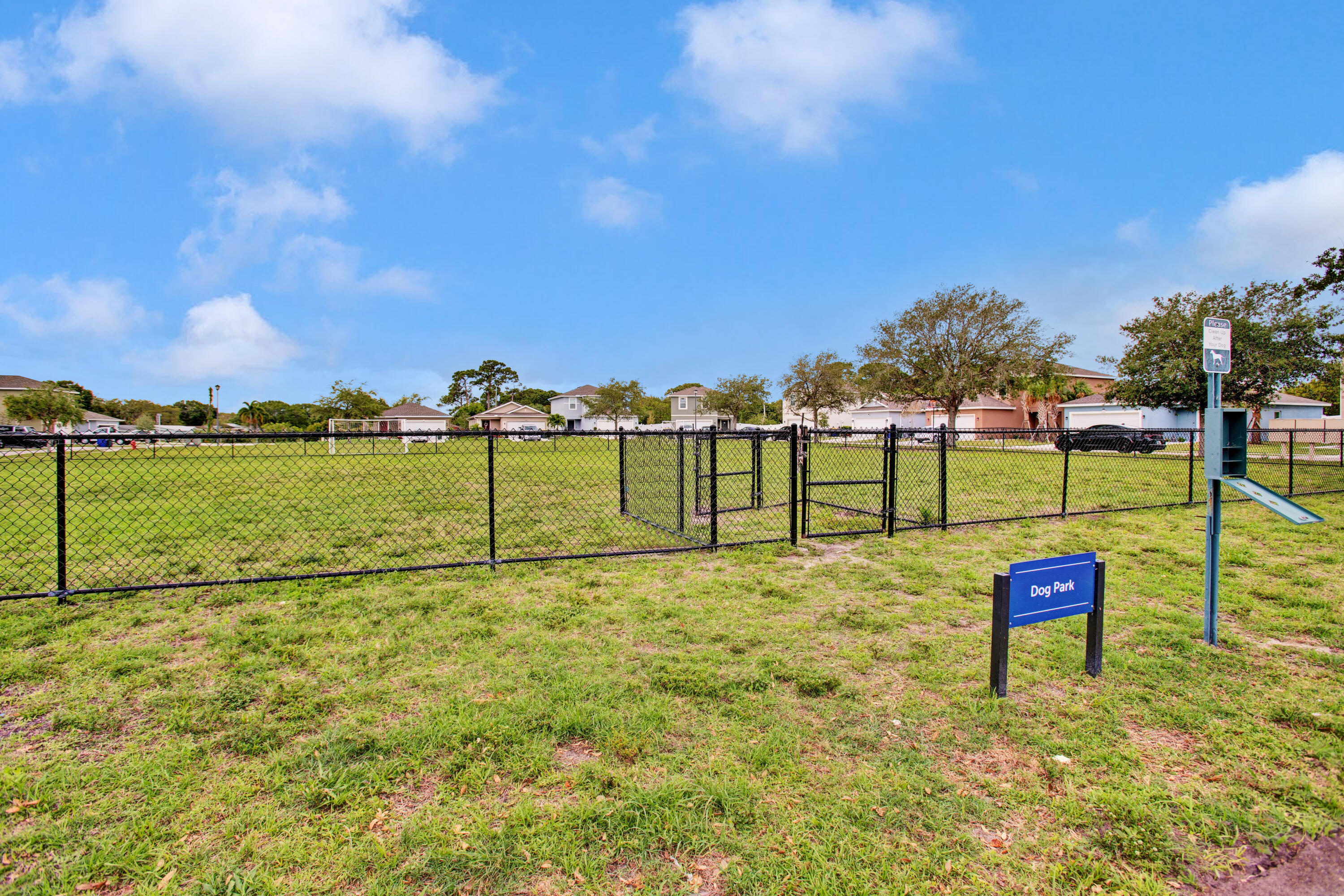 3343 Liberty Square Way, Unit 104 Fort Pierce, FL 34982 - Photo 31 of 34 a view of a lake with houses in the back