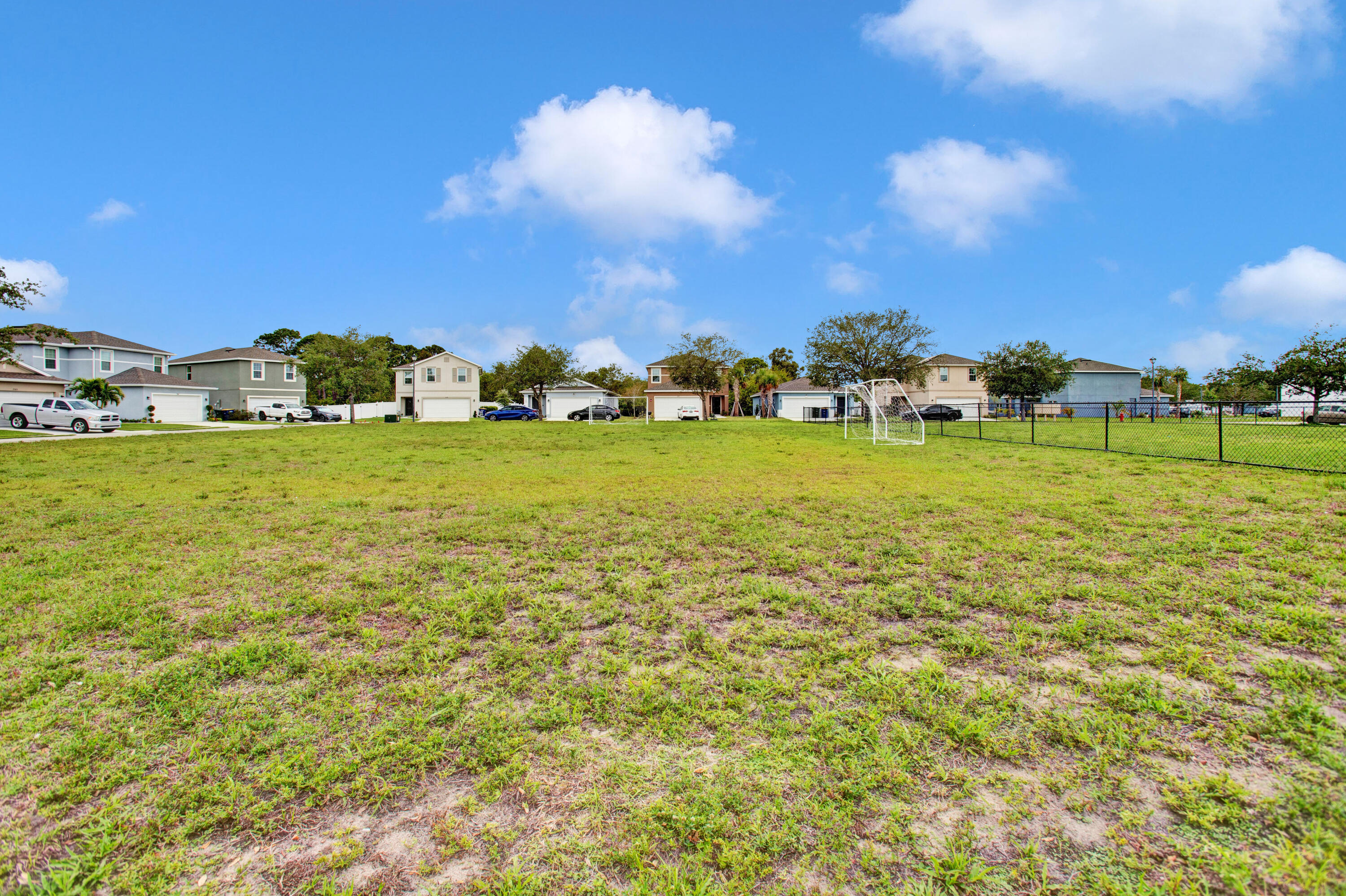 3343 Liberty Square Way, Unit 104 Fort Pierce, FL 34982 - Photo 33 of 34 a view of a big yard with a large trees