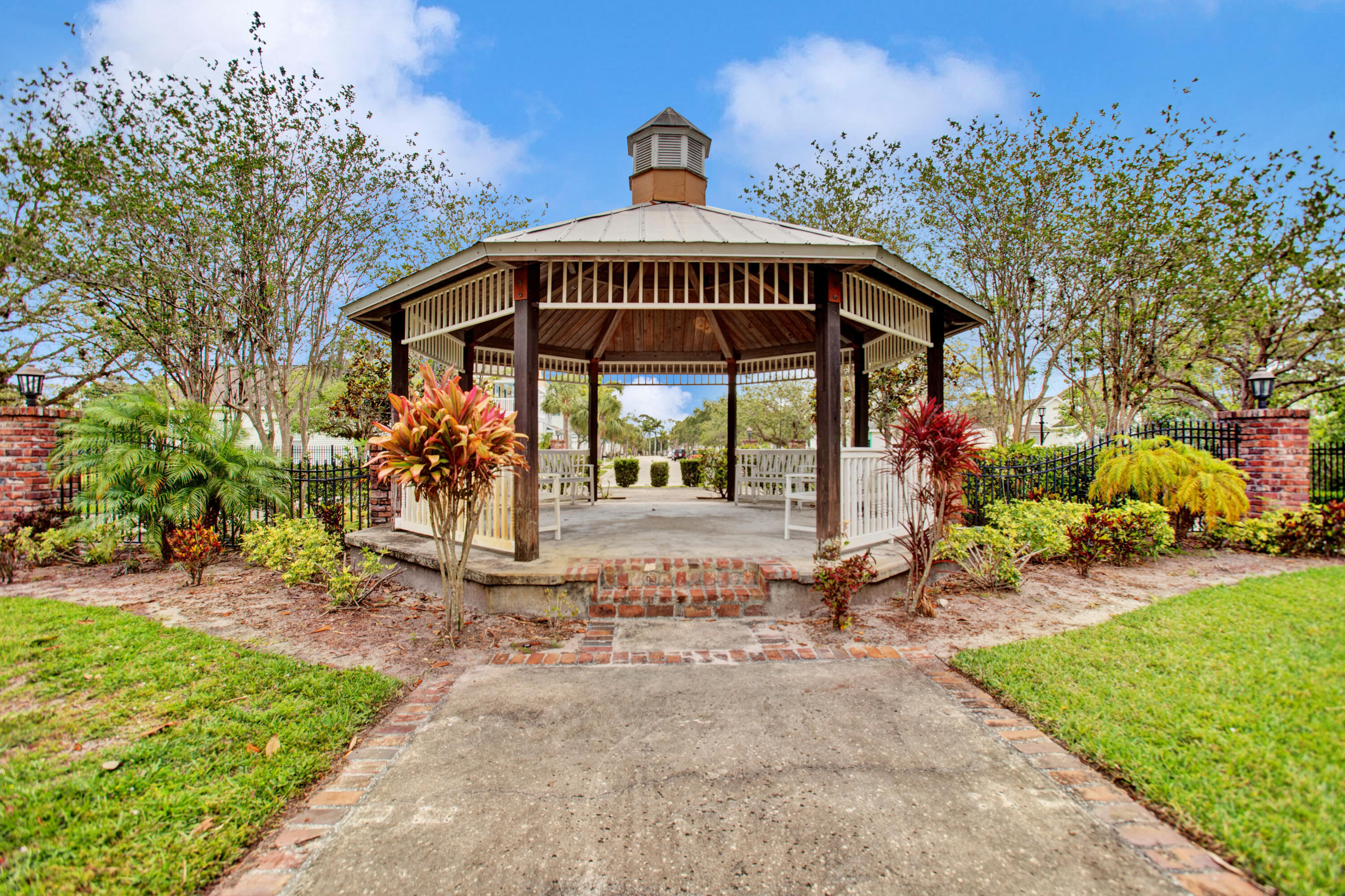 3343 Liberty Square Way, Unit 104 Fort Pierce, FL 34982 - Photo 34 of 34 a view of a patio with a table and chairs under an umbrella