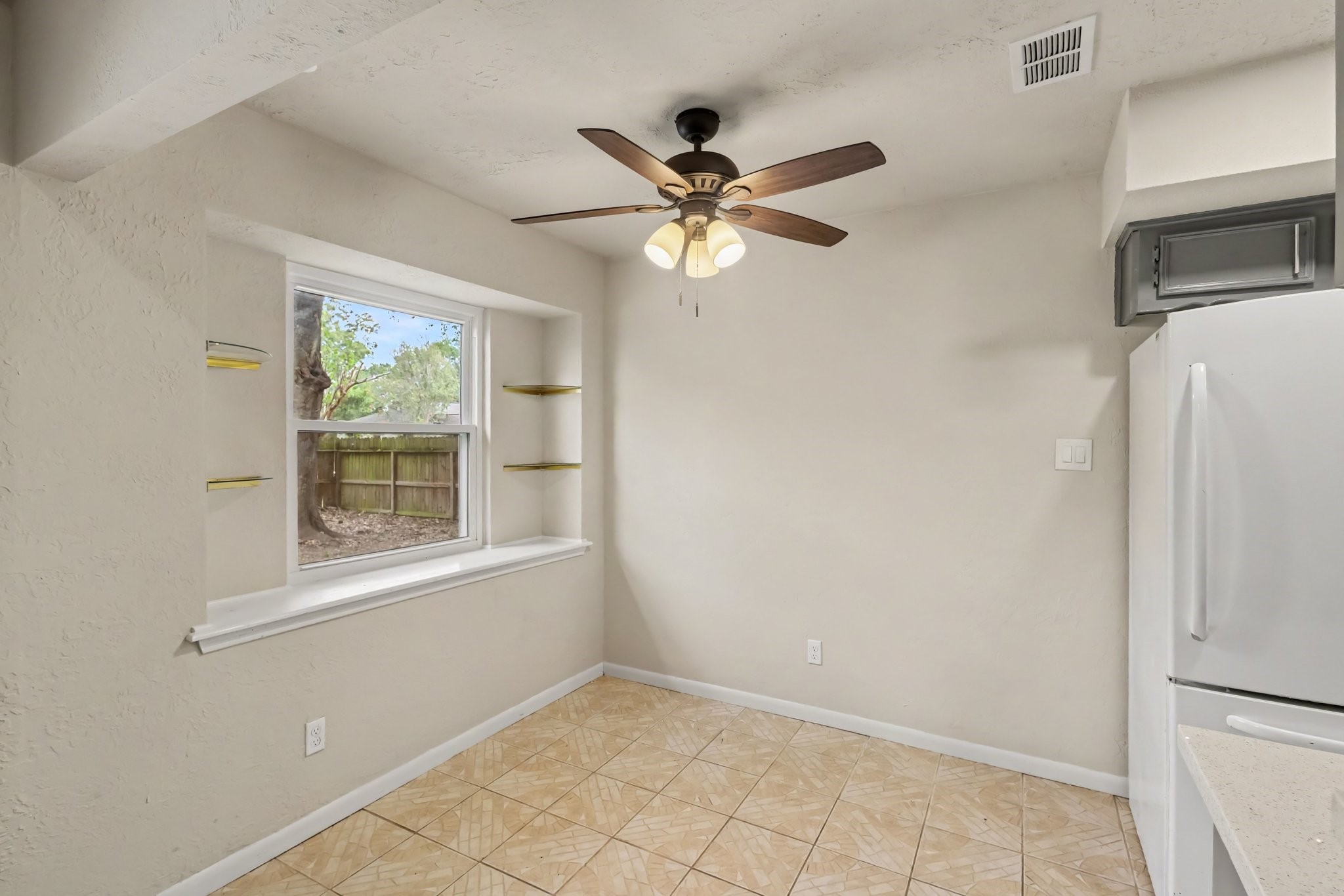 21902 Meadowhill Drive Spring, TX 77389 - Photo 19 of 28 Cozy dining nook with a ceiling fan and natural light from a large window, perfect for casual meals or morning coffee.