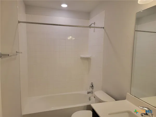 a bathroom with a shower and a toilet