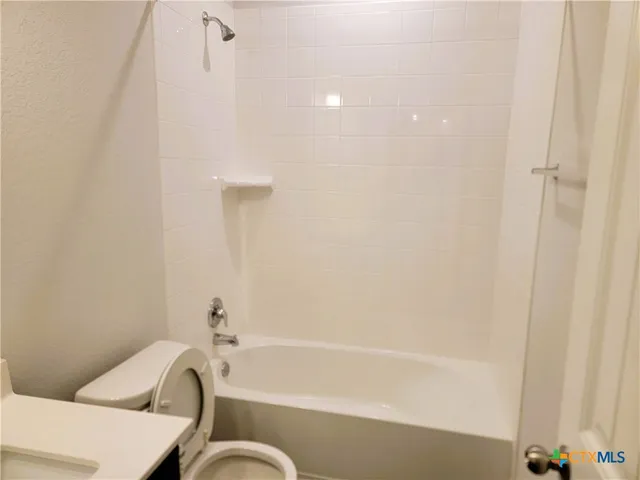 a bathroom with a bathtub and shower