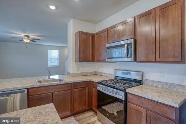 a kitchen with cabinets a sink and appliances