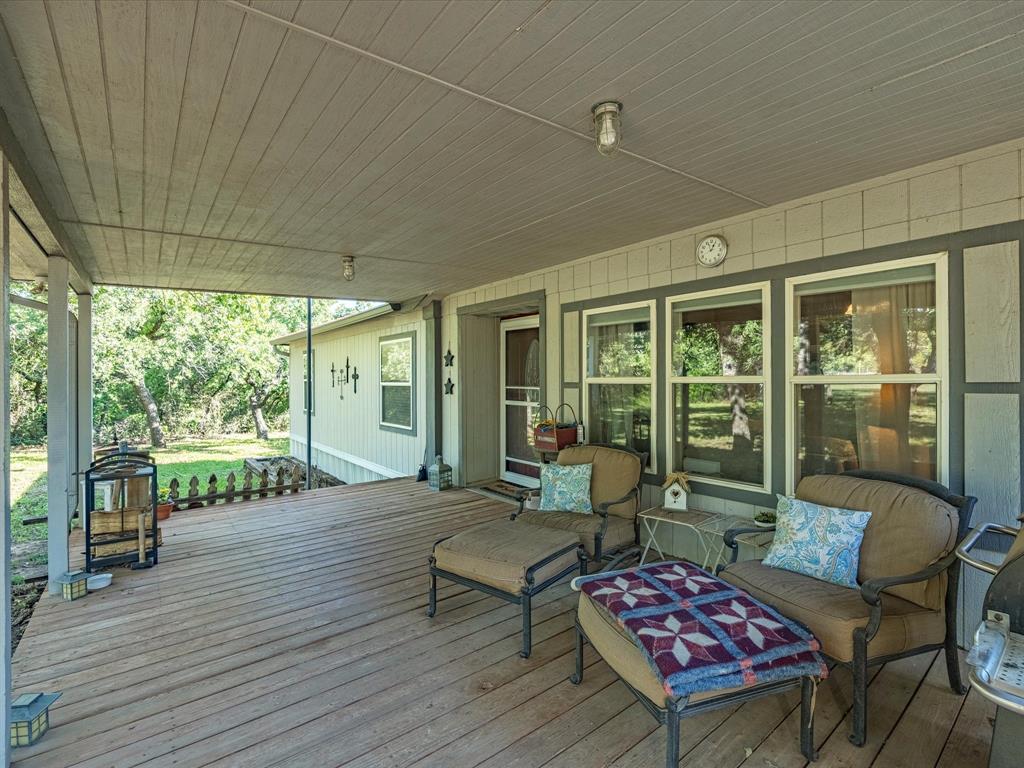 3275 Finis Road Graham, TX 76450 - Photo 4 of 36 a balcony with furniture and wooden floor