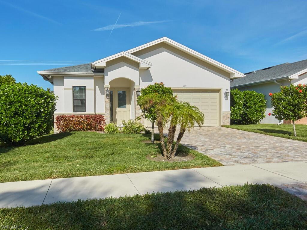 1119 Ridge Street Naples, FL 34103 - Photo 20 of 22 a front view of a house with a yard