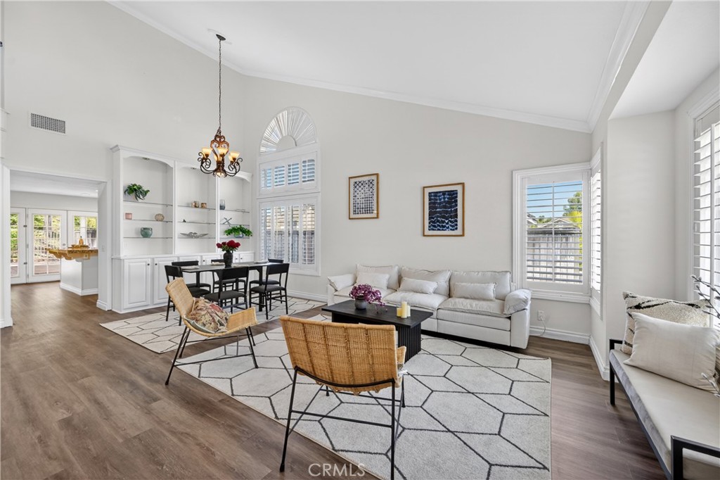 11562 Chadwick Road Corona, CA 92878 - Photo 2 of 39 Formal living room features new floor, plantation shutters, vaulted ceiling.