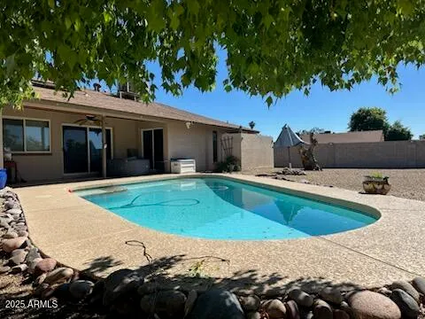 a view of a swimming pool with a patio