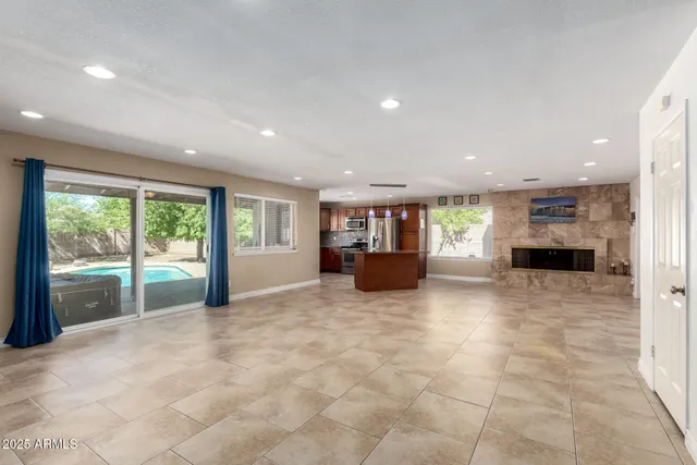 a view of an empty room with a fireplace and a large window