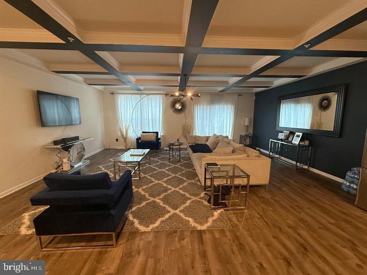 2805 Pinebrook Road, Unit 439 Landover, MD 20785 - Photo 16 of 36 a living room with furniture a flat screen tv and kitchen view