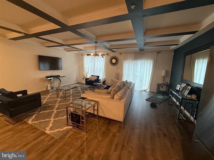 2805 Pinebrook Road, Unit 439 Landover, MD 20785 - Photo 17 of 36 a living room with furniture and a flat screen tv