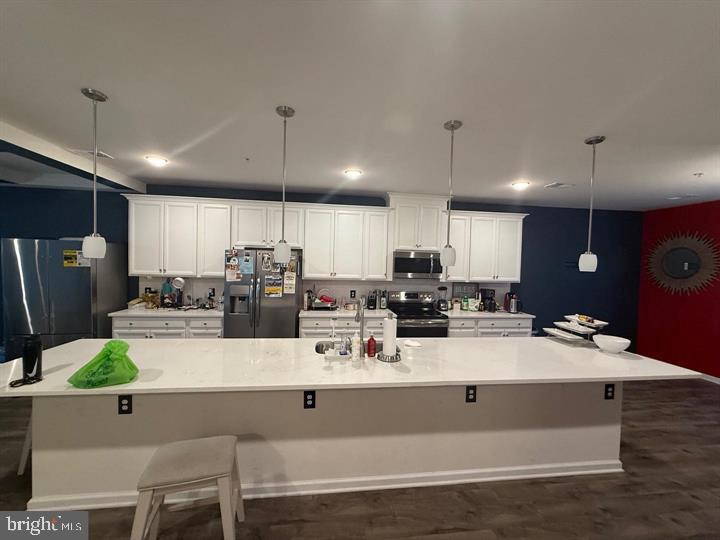 2805 Pinebrook Road, Unit 439 Landover, MD 20785 - Photo 3 of 36 a view of kitchen with stainless steel appliances kitchen island granite countertop a stove white cabinets a couches and chairs