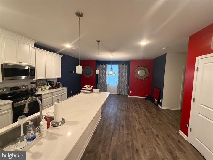 2805 Pinebrook Road, Unit 439 Landover, MD 20785 - Photo 4 of 36 a large kitchen with sink a refrigerator and chairs