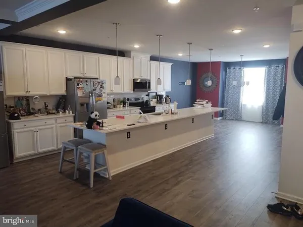 a kitchen with a sink cabinets and wooden floor