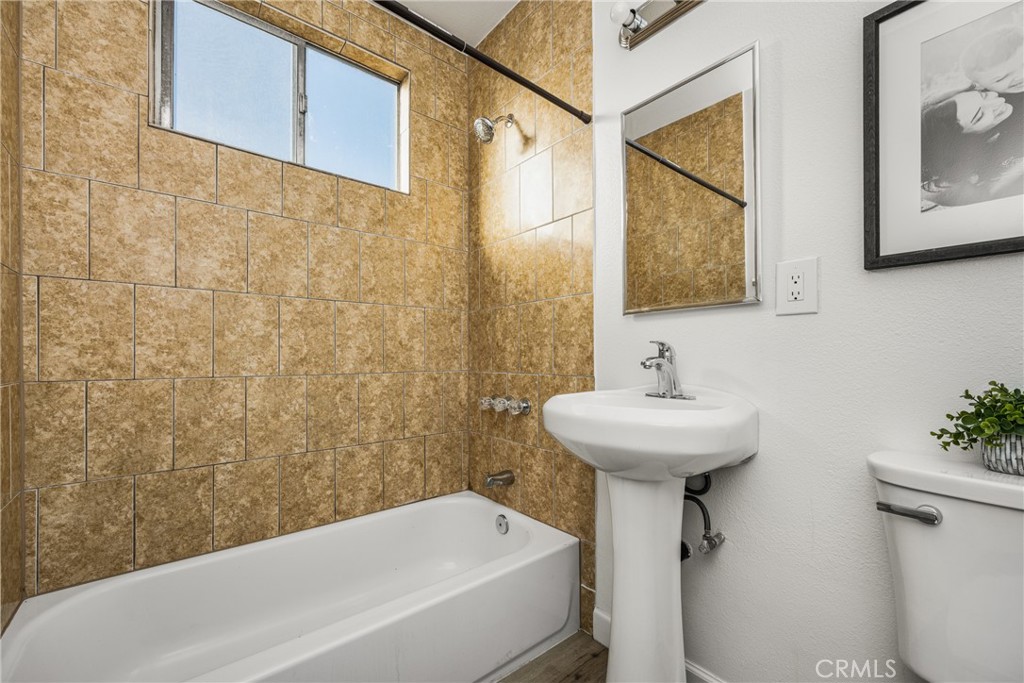 6725 Perry Road Bell Gardens, CA 90201 - Photo 29 of 40 a bathroom with a sink a toilet and shower