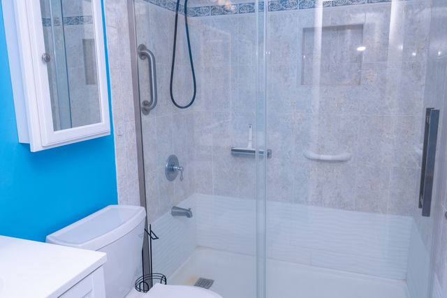 a bathroom with a bath tub with a shower