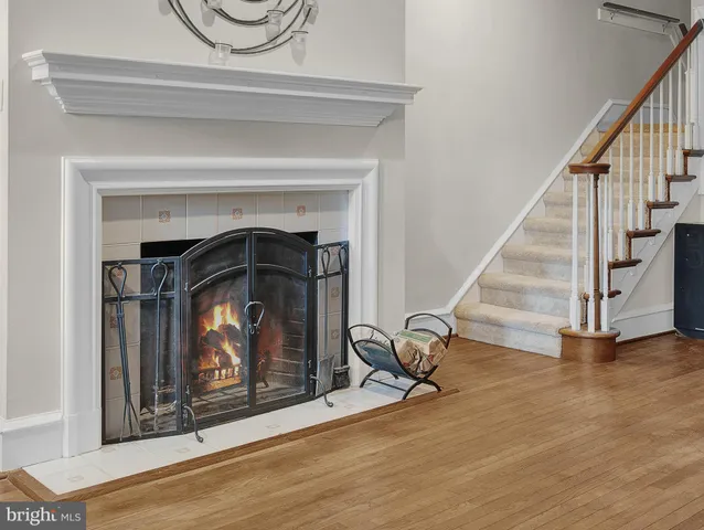a living room with stairs and a fireplace