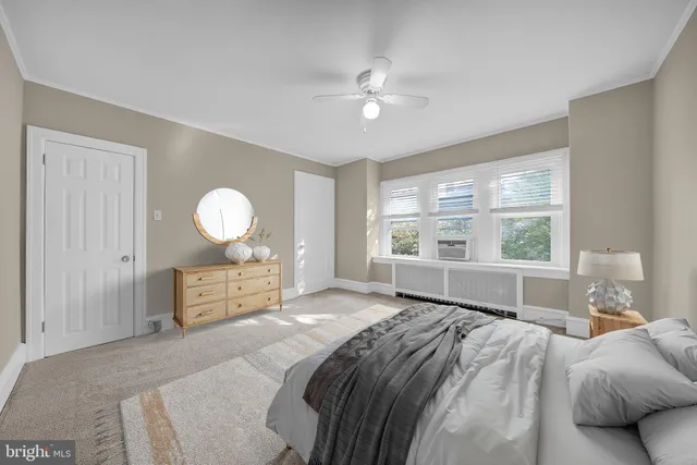 a bedroom with a large bed and window